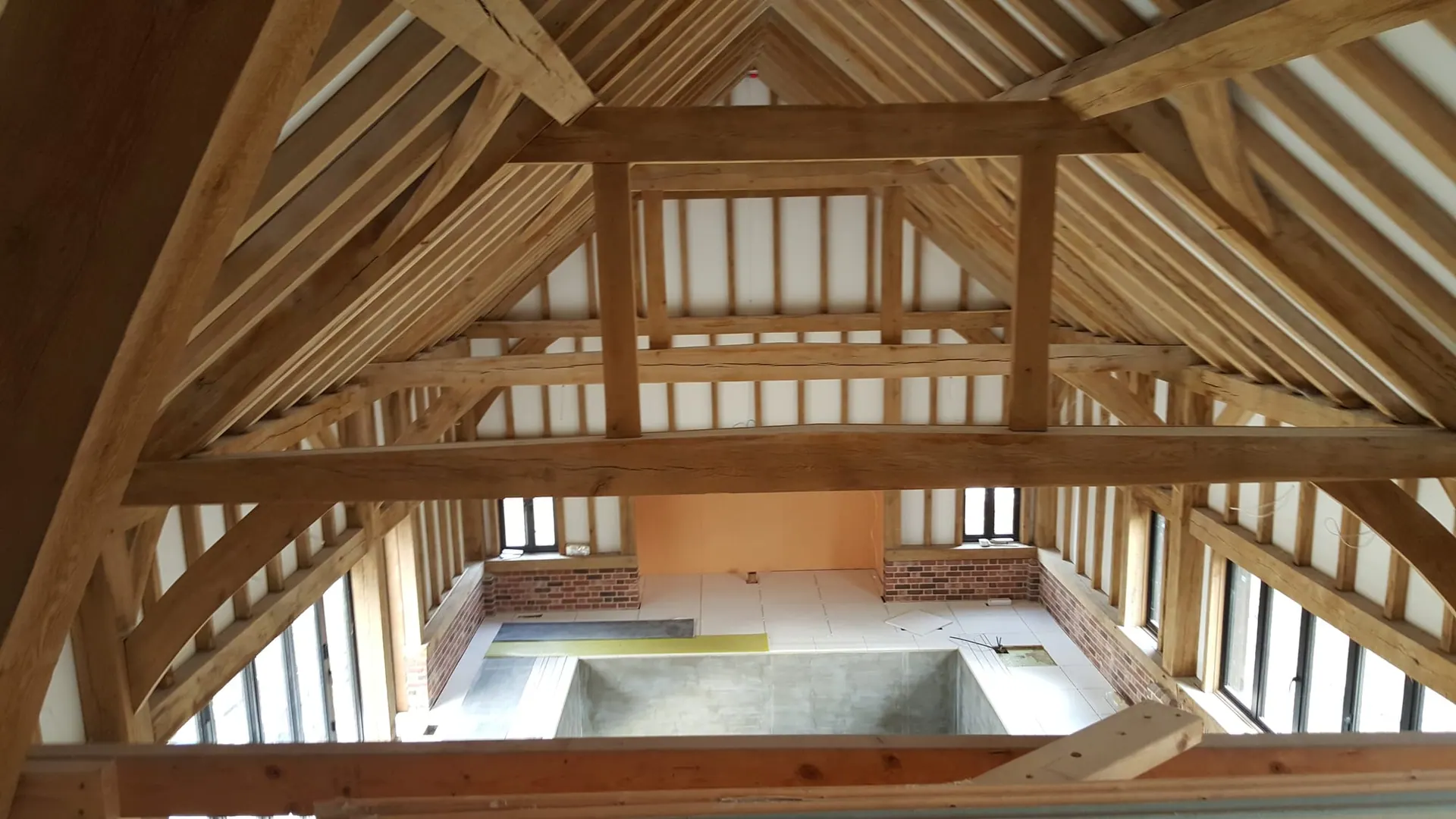 Exposed oak-frame roof trusses over a double-height room